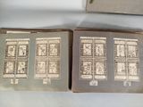 two old books with stamps on them on a table