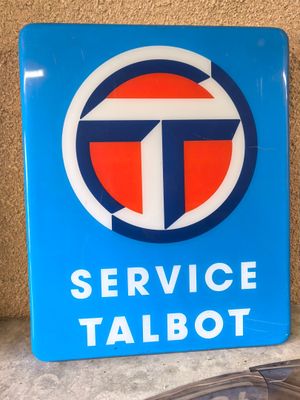 blue service talbot sign sitting on top of a counter next to a phone