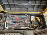 many tools in a tool box on the floor