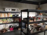 many shelves with various items on them in a room