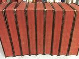 many books stacked on top of each other on a table