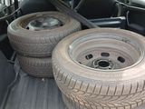two tires in the back of a car with the back door open