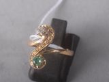 a gold ring with a green and white stone on it