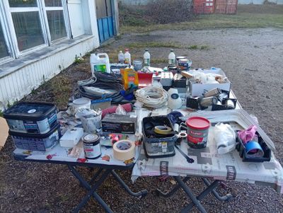 a table with a lot of stuff on it in front of a house