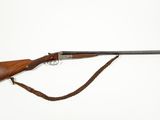 an old rifle with a wooden handle and a leather strap