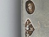 stickers on the side of a metal door with a picture of a man and a woman on it