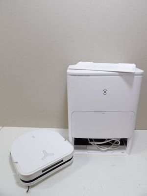 a white printer sitting on a table next to a white trash can