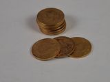 a pile of coins sitting on top of a white table