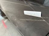a sticker on the hood of a car that is parked in a parking garage