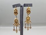a pair of gold toned earrings with dangling charms