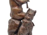 bronze statue of a boy with a dog on a marble base
