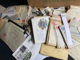 a box full of old letters and envelopes on a table