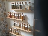 many jars of spices on the shelves in the kitchen