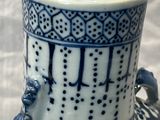 a blue and white vase with a bird on it