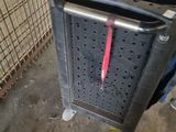 a trash can that has a red handle on it