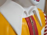 statue of ronald the clown in a red wig and yellow shirt