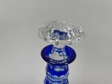 a blue glass vase with a diamond on top