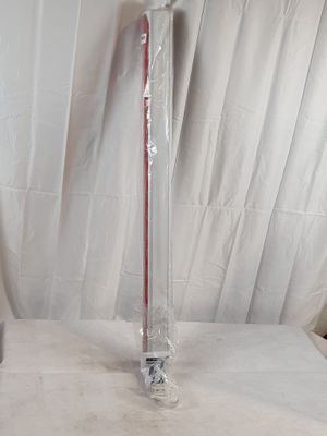 un vase en verre avec une anse rouge posé sur une table blanche