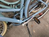a blue bicycle parked on the side of the street