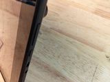 a close up of a cell phone on a wooden table