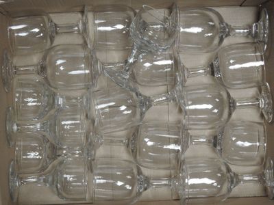 many empty wine glasses in a box on the table