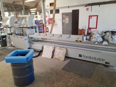 a picture of a machine in a factory with a trash can in front of it