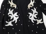 a black jacket with gold sequins on the shoulders