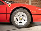 a red sports car that is parked in a garage