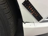 a sticker on the bumper of a white car with a calculator on it