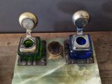 two small glass bottles sitting on top of a wooden table