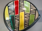 a colorful bowl sitting on top of a table