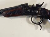 an old gun on a wall with a tag attached to it