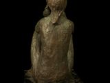 statue of a woman sitting on a marble block