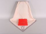 a red purse sitting on a white table next to a white towel