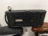 a small black bag sitting on top of a chair