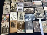 several old black and white photographs of people and animals on a table
