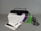 a black webcam sitting on top of a white box
