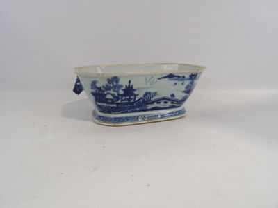 a small blue and white bowl with a bird on it