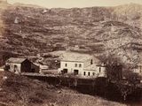 a black and white photo of a village in the mountains