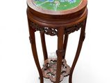 a small wooden table with a green and blue design on it