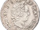 a silver coin with a woman ' s head on it