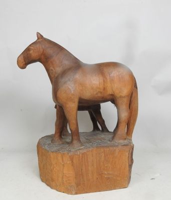 statue représentant un cheval et un poulain debout sur un bloc de bois