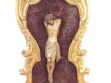 a statue of jesus on the cross on a stand