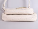 a pair of white purses sitting on top of each other