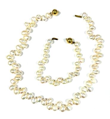 necklace and earring set with white pearls on a white background