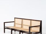 an image of a wooden bench with a woven seat on it