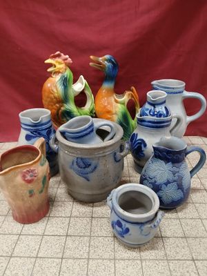 many different types of vases sitting on a table