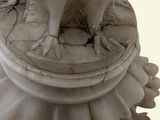 a statue of a dog sitting on top of a pedestal