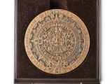 an image of a gold plate in a wooden box