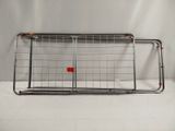 a large metal cage with a red button on it